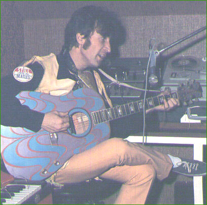 14: John Lennon sings and plays in his private recording studio in his home at Kenwood, circa 1966. Note John’s psychedelic painted guitar.