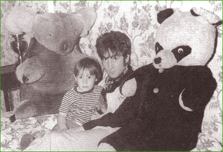 12: John Lennon and his son, Julian, strike a relaxing pose together amongst some of Julian’s oversized stuffed animals. This photo session took place in 1966 at John’s home in Kenwood, Weybridge, England.