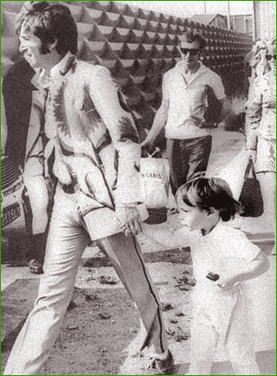 16: John Lennon leads his son, Julian, by the hand, as they return to England from a trip to Greece in 1966. Note John’s amazing giant flower-covered psychedelic jacket. Far out, man!
